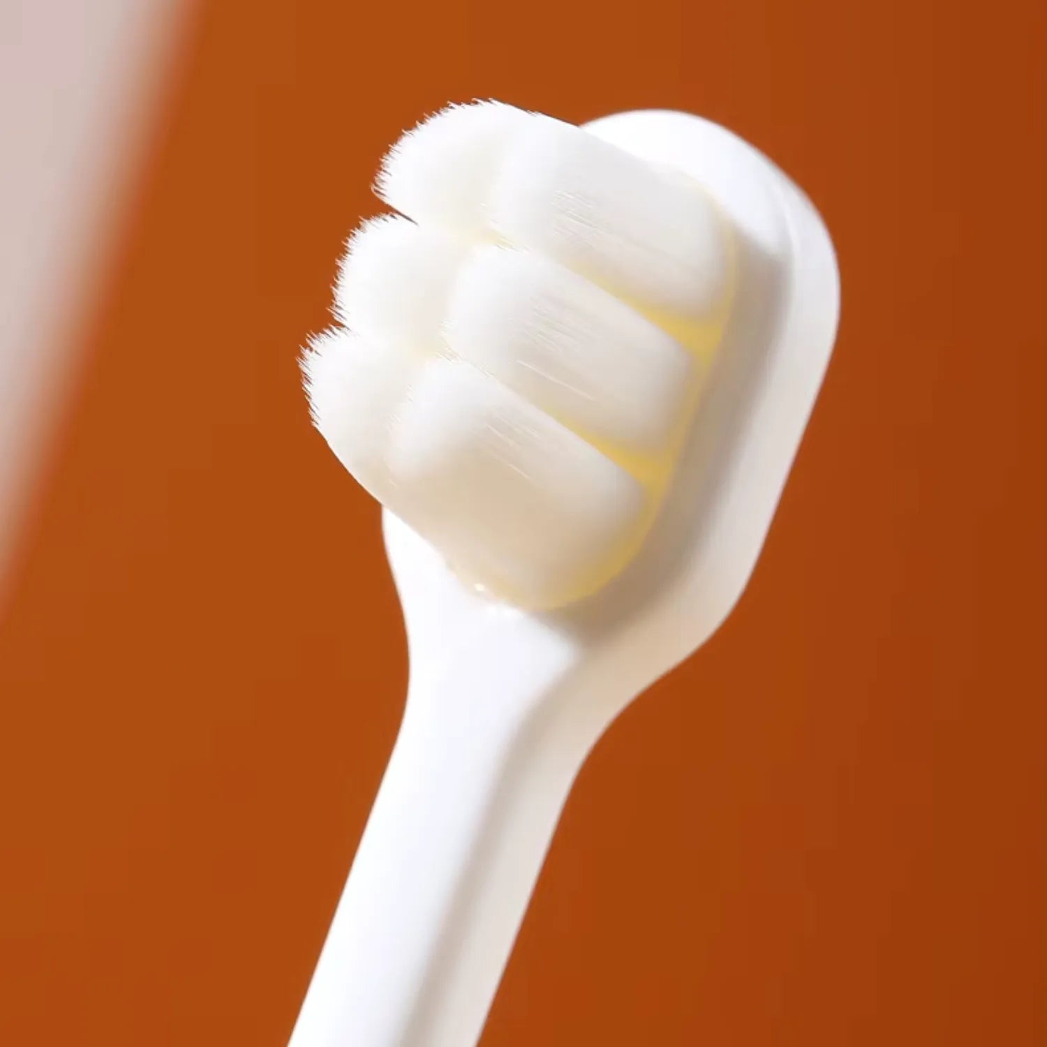 Close-up of dinosaur kids toothbrush showing soft bristles and child-friendly handle for toddlers