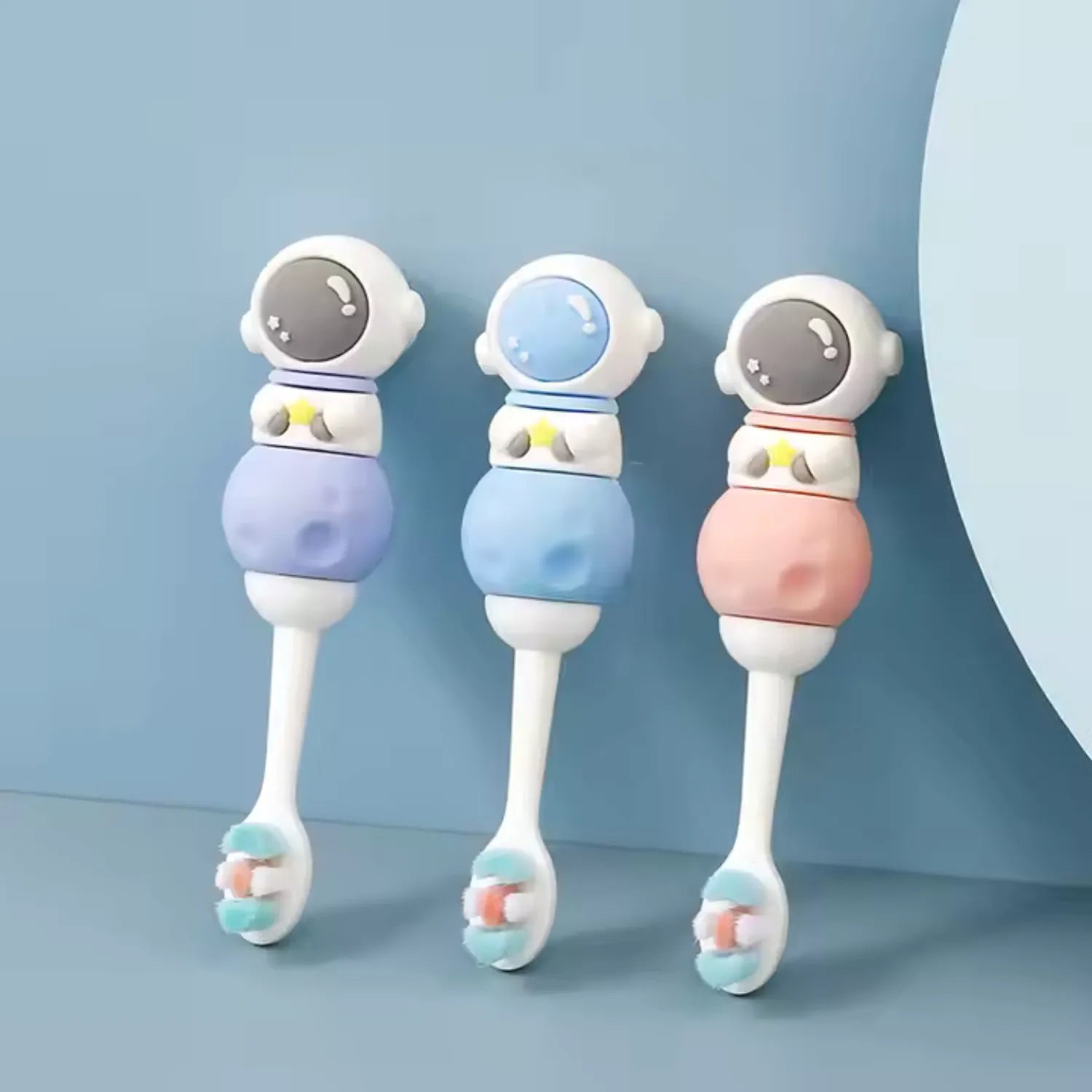 Colourful astronaut kids toothbrushes in blue pink and purple designed for fun daily oral care routines