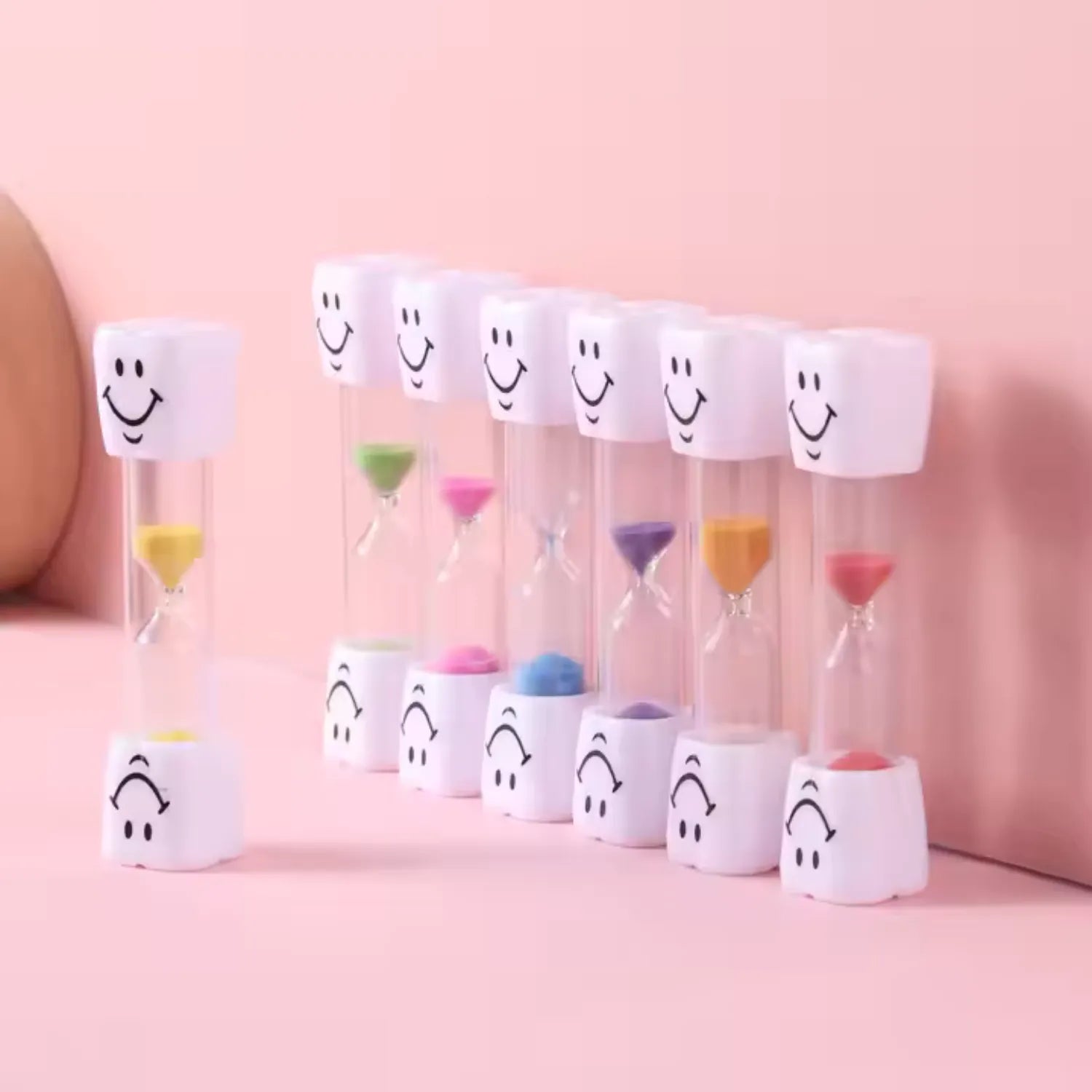 Kids tooth brushing sand timer set showing multiple colourful timers for healthy brushing habits and routines
